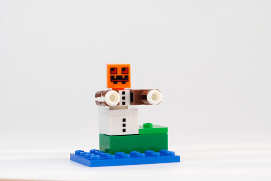 Minecraft Snow Golem character with pumpkin head and outstretched arms standing on a blue base against a white background on Sep 21, 2026 in Jakarta, Indonesia