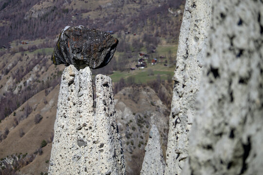 Close-up view of the Pyramids of Euseigne, natural earth pyramids topped with glacial boulders in Valais, Switzerland