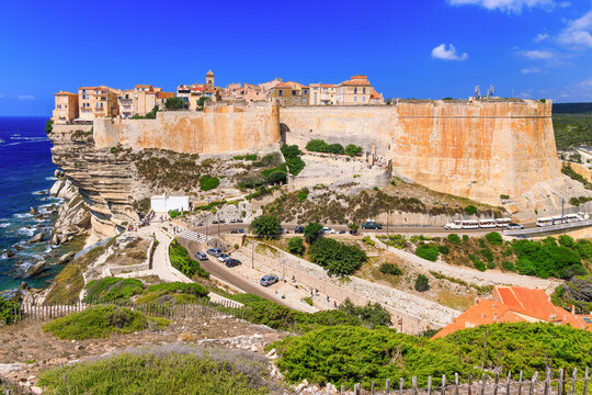 Corsica France. View of Bonifacio Old Town Perched on White Limestone Cliffs. Medieval Citadel above Turquoise Sea and Eroded Rocks.