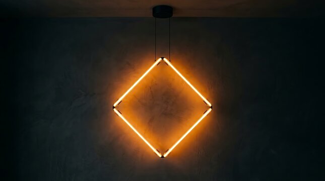 Illuminated diamond shaped light fixture hangs against a dark textured wall