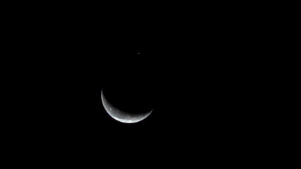 Waning crescent moon and planet Jupiter during astronomical conjunction © Alexander