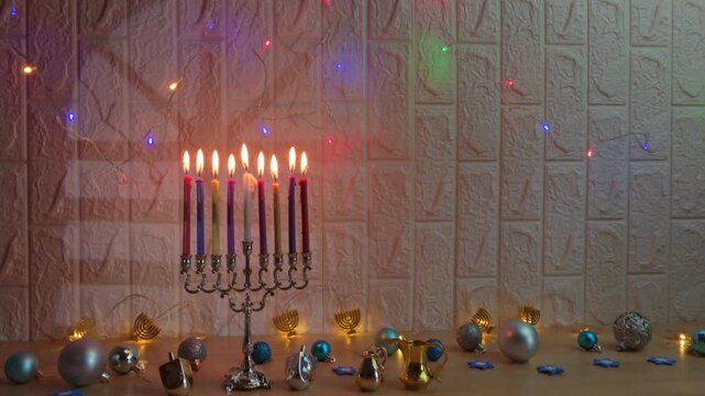 Hanukkah menorah with burning candles and dreidels