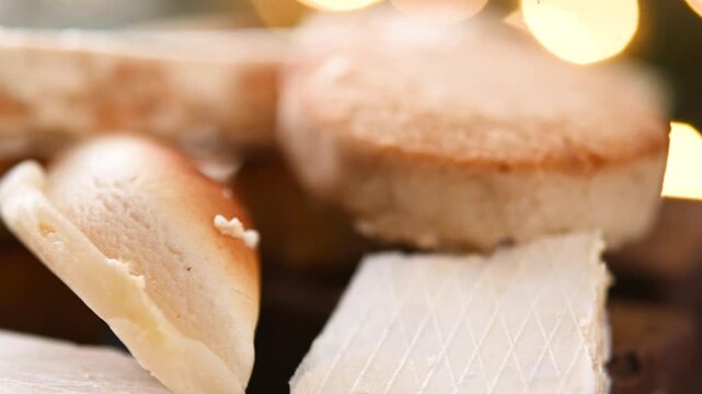 Close-up video of traditional Spanish turrones and polvorones rotating on a plate. Assorted festive sweets typical of Christmas in Spain presented as a seasonal holiday dessert.
