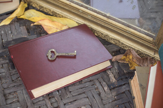 Vintage key arranged in an atmospheric antique setting, symbolizing the discovery of secrets, hidden knowledge and answers to unanswered questions. Mysterious conceptual still life evoking spiritual 