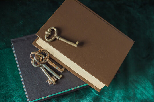 Vintage key arranged in an atmospheric antique setting, symbolizing the discovery of secrets, hidden knowledge and answers to unanswered questions. Mysterious conceptual still life evoking spiritual 