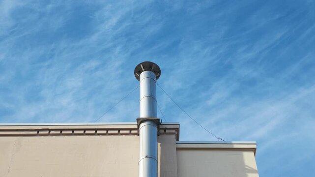 Industrial Stainless Steel Exhaust Stack on Concrete Building Roof