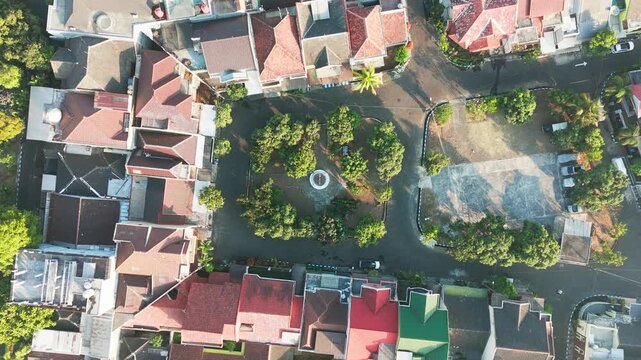 Aerial view of a residential neighborhood with houses, rooftops, and a central park area in Malang, East Java, Indonesia.