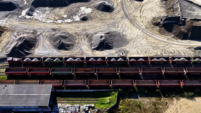 Aerial view of train cars loaded with stone at the Dolomitas industrial site in Petrasiunai, Siauliu apskritis, Lithuania.
