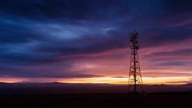 Sunset sky with vibrant colors behind towering structure and fireflies glowing in twilight nature scene