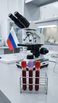 Laboratory microscope and blood test vials on a lab table. Plague in Russia  
