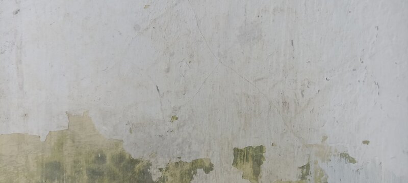 Weathered white painted plaster surface texture with subtle hairline cracks and peeling edges, ideal for minimalistic grunge backgrounds and architectural mockups