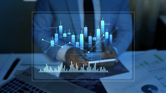 Holographic business investment analysis with stock market chart animation, Businessman using a smartphone beside a laptop and financial reports, with a glowing blue stock chart overlay.