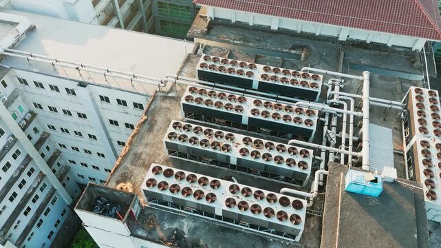 Aerial view of industrial HVAC cooling units installed on a building rooftop in Malang, East Java, Indonesia.