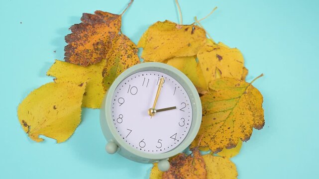 End of daylight saving time in autumn, winter time changeover, alarm clock fall back switch, colorful foliage