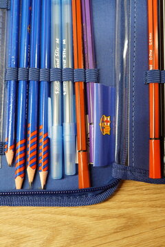 Organized blue pencil case filled with various writing instruments and school supplies for study