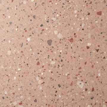 Dusty pink terrazzo texture with red white and grey stone fragments