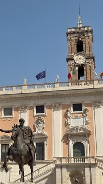 Equestrian statue of Marcus Aurelius in front of Palazzo Senatorio with its historic clock tower on Capitoline Hill, Rome.