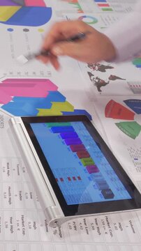 Team analyze charts graphs and tablet data