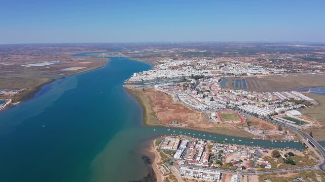 Panoramic aerial perspective of ayamonte, a city in spain, situated at the mouth of the guadiana river with the international bridge connecting to portugal visible in the background