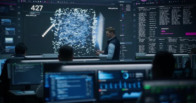 Portrait of a Chief Data Officer Using a Tablet Beside a Glowing Neural Network Map in a Business Statistics Monitoring Room as Analysts Track Banking Dashboards, Ecommerce Shipping and Fraud Alerts.