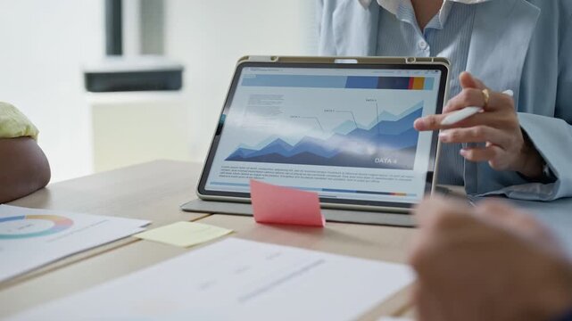 Business team meeting brainstorming ideas,data trend and analyzing stock market charts on tablet,colleagues working together planning success strategy enjoy in modern office.statistics success concept