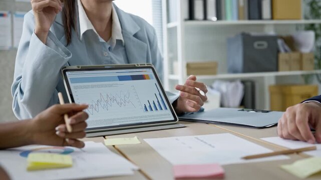 Business team meeting brainstorming ideas,data trend and analyzing stock market charts on tablet,colleagues working together planning success strategy enjoy in modern office.statistics success concept