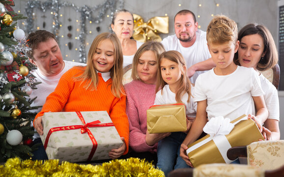 Big family is celebrating New Year together and talking at table indoors