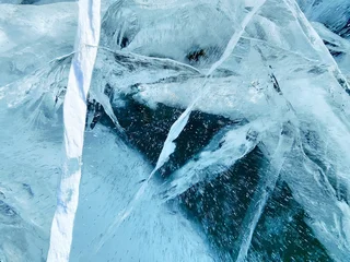 A close up of blue ice and deep glacial cracks with ice shards on Lake Baikal in Siberia. Natural winter ice formation view © Viks_jin