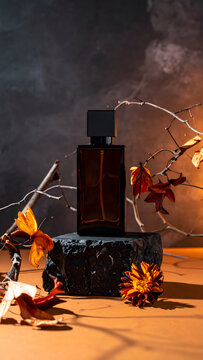 Dark Moody Luxury Autumn Fragrance: Moody autumn fragrance display featuring dark amber glass perfume bottle