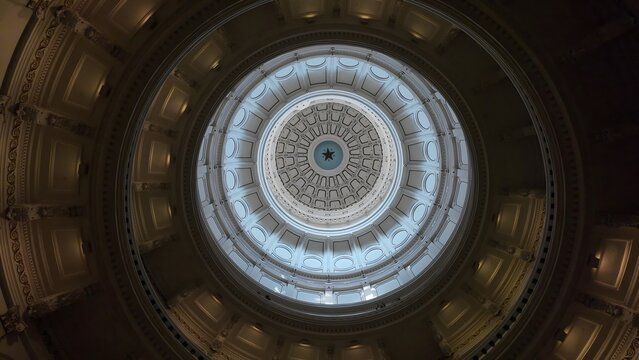 Austin, Texas, United States - 28 April 2024: View of the ornate interior dome of the Texas Capitol, featuring a central star and intricate architectural details.