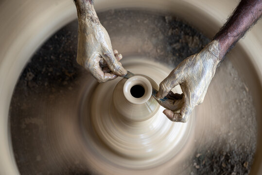 Joypurhat, Rajshahi Division, Bangladesh - 28 September 2026: View of a potter's hands shaping a clay pot on a spinning wheel.