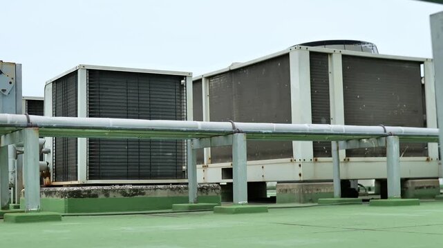 Modern outdoor cooling system featuring condenser coils, refrigerant piping and industrial HVAC equipment for temperature control.