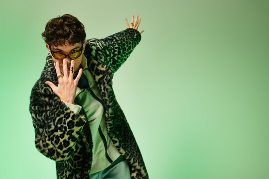 Stylish young man striking a fashionable pose in a vibrant setting