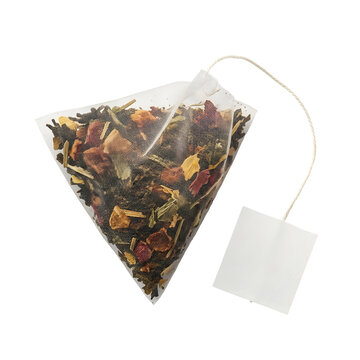 Pyramid tea bag with dried fruit and herbal leaves on transparent background