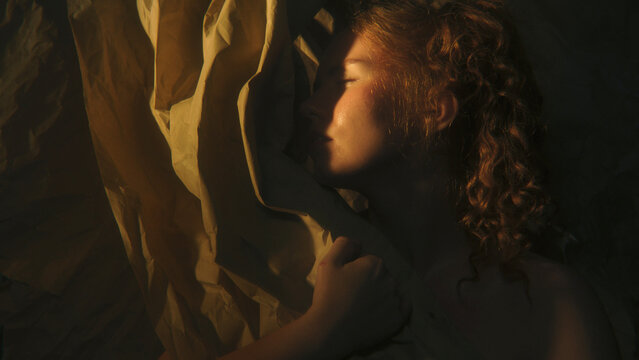 Female Portrait Divided Between Golden Illumination and Deep Shadow Explores Emotional Duality, Uncertainty and Inner Conflict. Striking Contrast Creates Conceptual Image About Opposing Feelings.