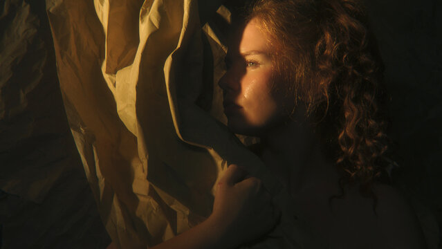 Authentic Feminine Portrait Celebrating Natural Womanhood, Individuality and Self Acceptance. Curly Hair, Expressive Features, Warm Sunlight, and Organic Paper Textures Create Intimate Mood.