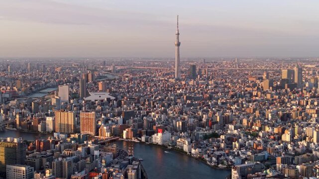 Aerial view of the Sumida River, Skytree and Tokyo cityscape at sunset, Sumida Ward, Tokyo, Japan.