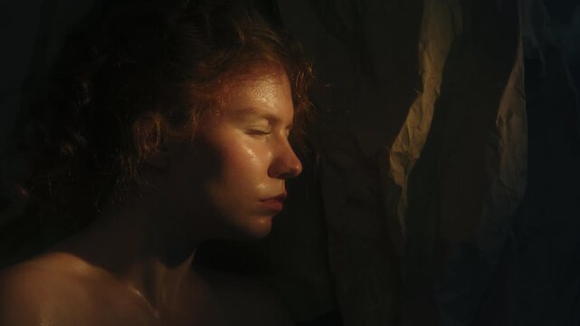 Red Haired Woman Retreats Behind Fragile Paper Barrier, Creating Metaphor For Self Protection and Feeling Exposed. Cinematic Shadows and Warm Light Convey Vulnerability and Emotional Openness.