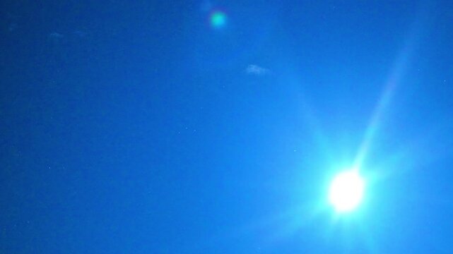 Abstract Blue Sky Background with Sunbeam Flare and Copy Space