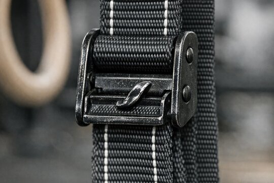 Close-up shot of a belt with a shiny metal buckle