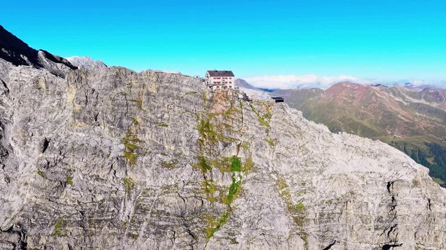 Aerial view of Payer Hut perched on the rocky cliffs of Ortler Mountain in the Alps near Sulden, Trentino-Alto Adige, Italy.