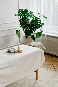 Massage table with towels and lotion bottle in beauty clinic