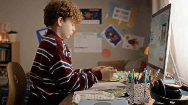 Caucasian teenage boy taking online lesson via computer, shaping clay during remote video call with tutor. Footage suitable for e learning platforms and virtual tutoring ads