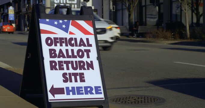 Official ballot return site sign displayed along a busy street, representing voting, elections, democracy and ballot collection in the United States. 15442  