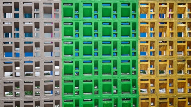 Colorful ventilation concrete blocks wall in grey green and yellow pattern