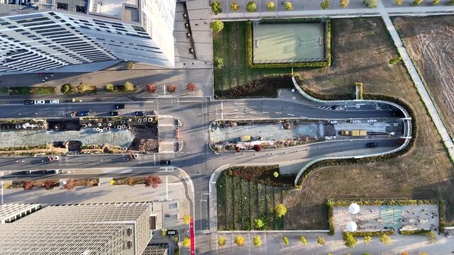 Aerial view of the Messe Frankfurt construction site with ongoing roadwork, modern architecture, and surrounding urban infrastructure in Frankfurt am Main, Hessen, Germany.