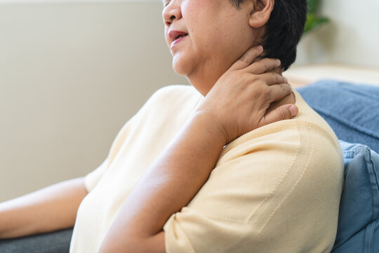 Asian middle-aged woman suffering from severe neck pain