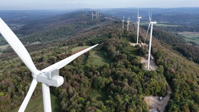 Aerial view of the wind turbines at Parc eolien du Lomont situated on a forested ridge in Vyt-les-Belvoir, Bourgogne-Franche-Comte, France.