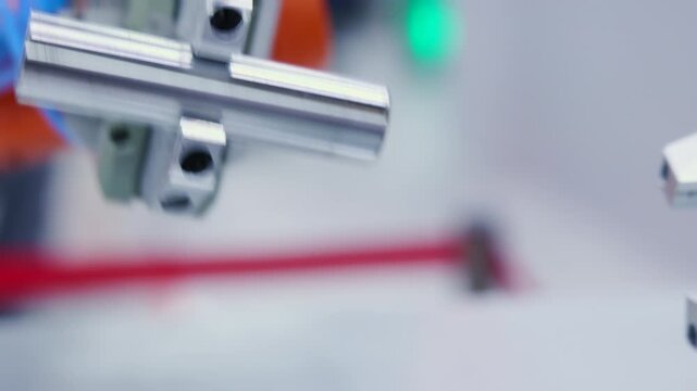 Polished steel rod clamped in machined metal fixture on industrial bench for close inspection of surface finish and alignment precision engineering workshop detail