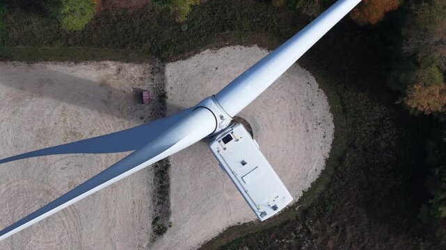 Aerial view of Parc eolien des trois cantons with rotating blades above the gravel base in Etouvans, Bourgogne-Franche-Comte, France.